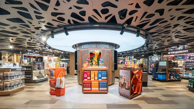 Circular central product display and ceiling feature inside the airport store.