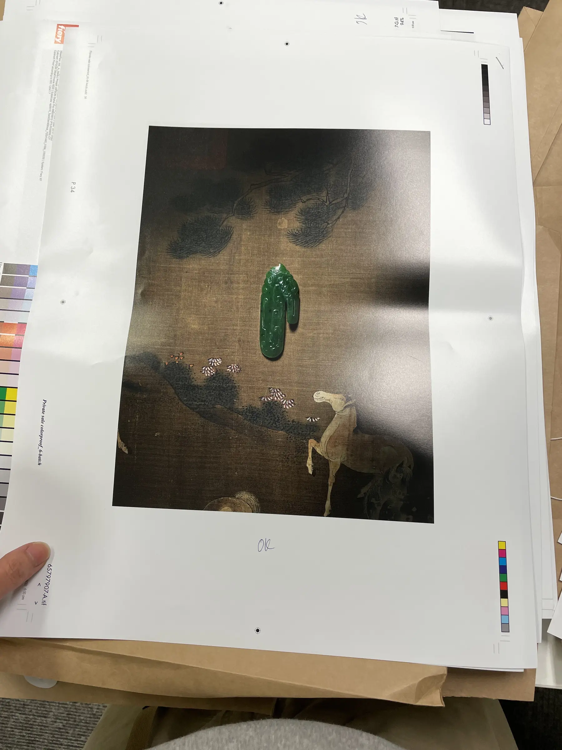 Third proof sheet held for inspection.