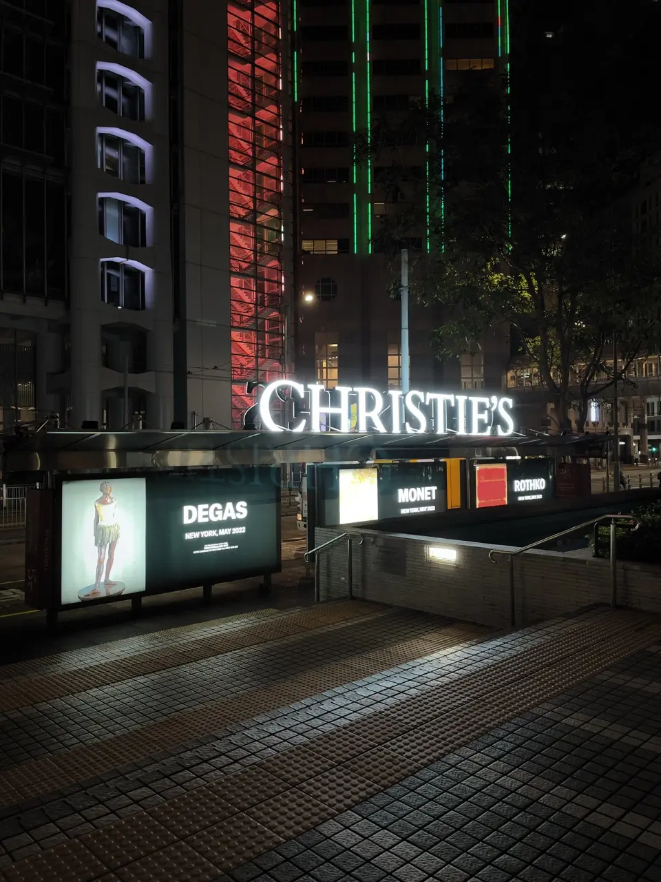 Christie’s illuminated urban façade / projection at night.