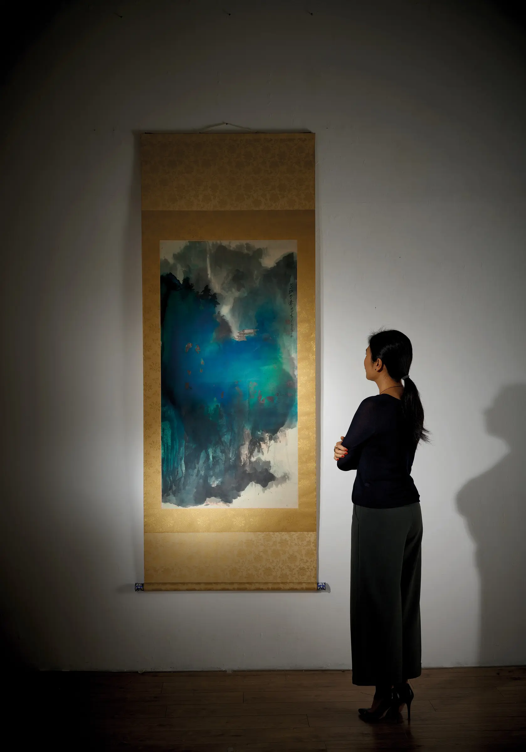 Visitor viewing a hanging scroll in the gallery.