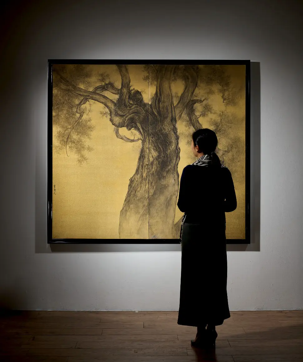 Visitor viewing a large painting.